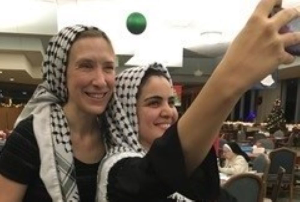 Asrar Jaber takes a selfie with Sr. Quincy Howard after they performed the dabke, a dance, at a holiday event at the Dominicans' Sinsinawa motherhouse. 